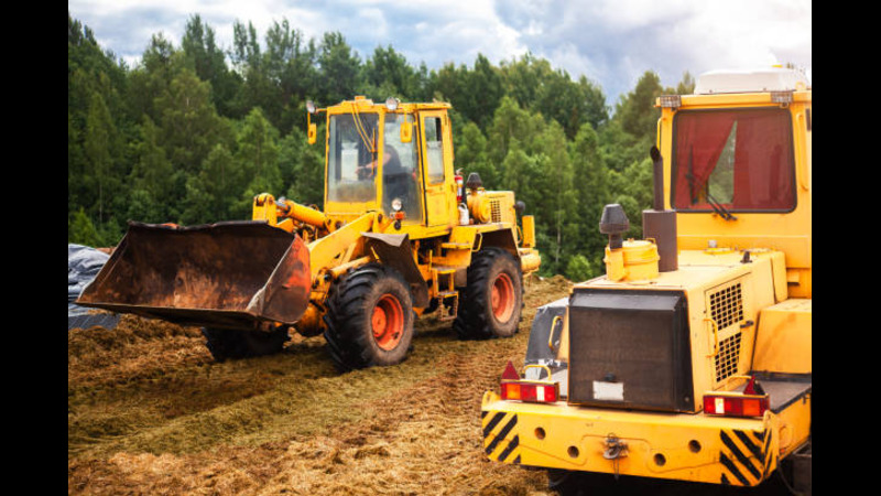 A wheel loader leveling the ground. 