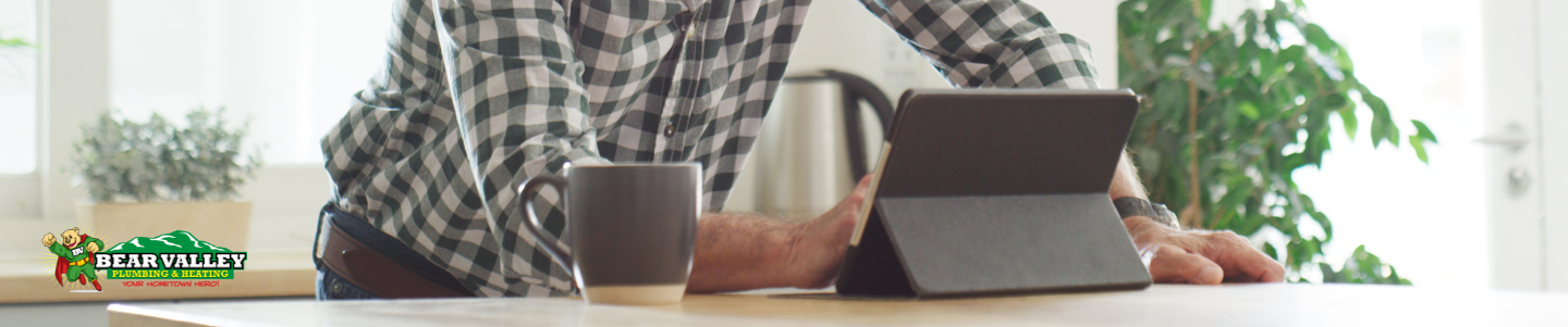 Homeowner researching HVAC and plumbing contractors online in Big Bear CA