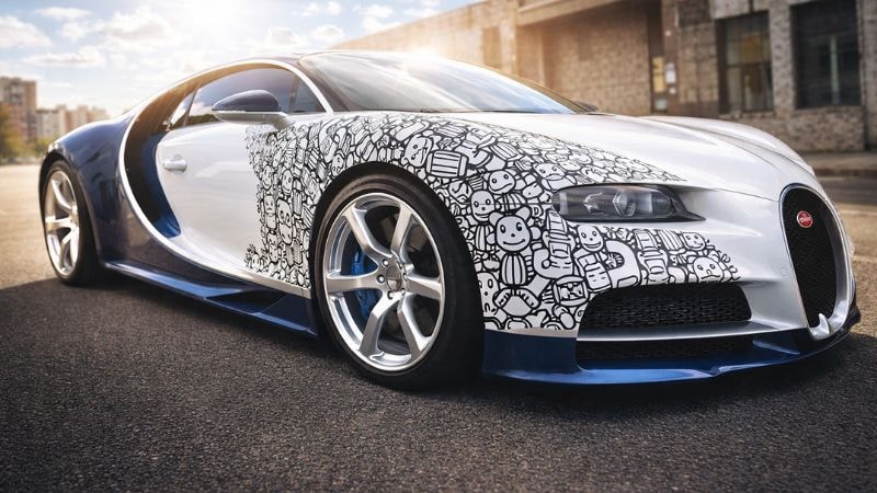 A Bugatti wrapped in crazy vinyl wrap on half of the car for crazy look
