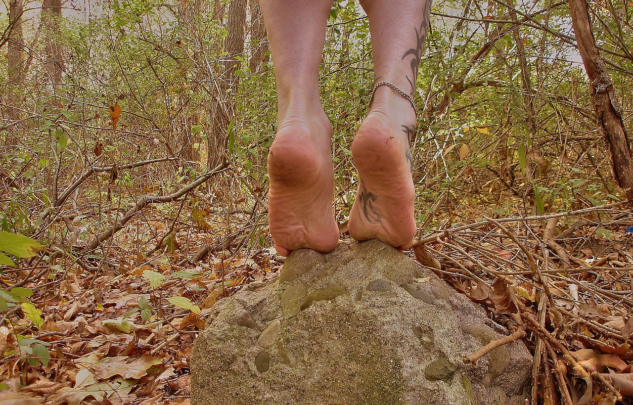  Two bare male feet on a rock