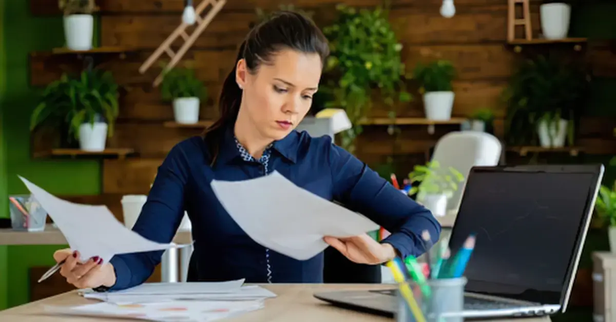 Woman reviewing IRS notice and refund details while asking can a judgement take your tax return.