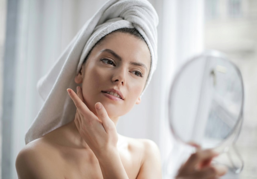Woman using high quality towel for skin and hair care