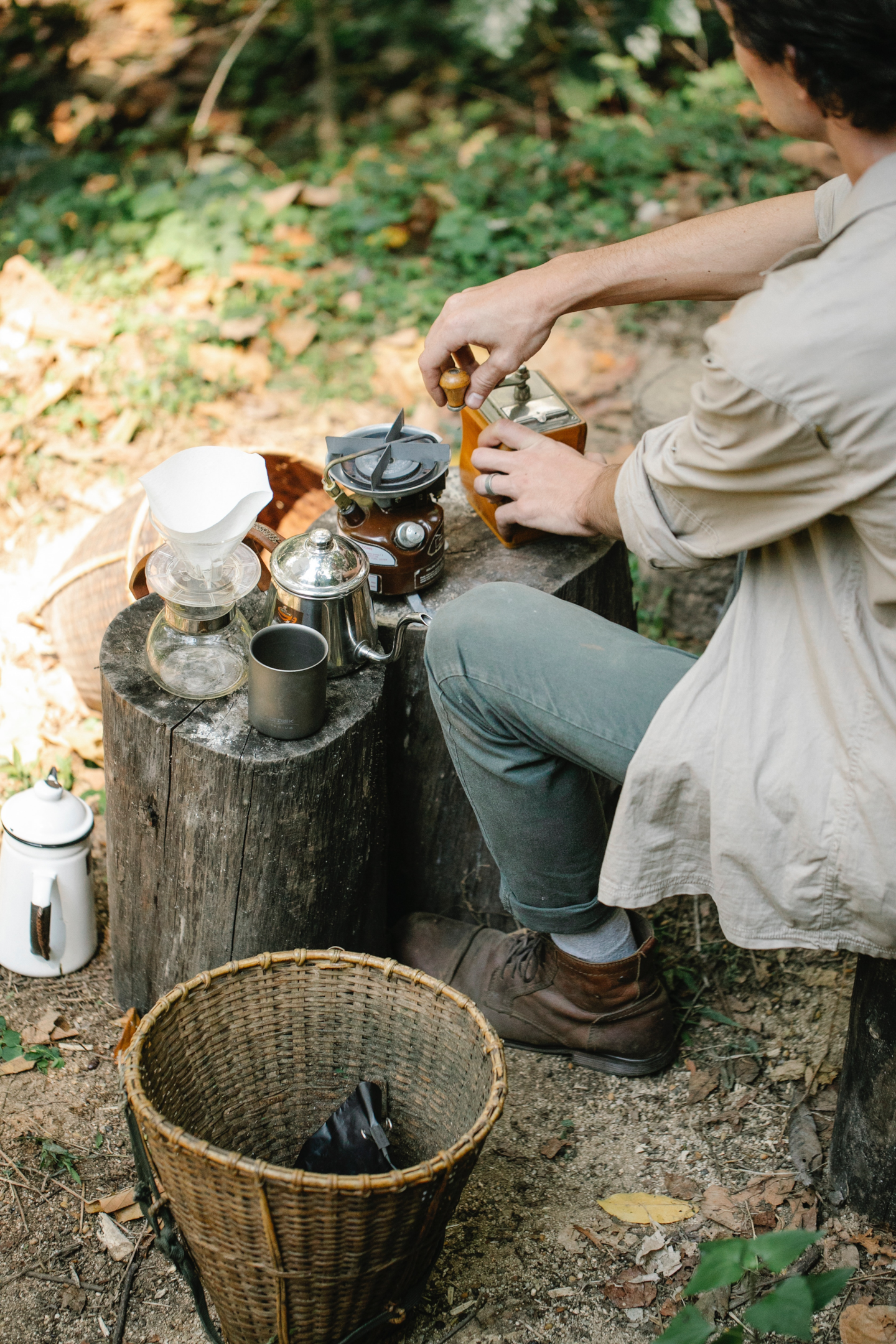 man grinding coffee for brewing outdoors