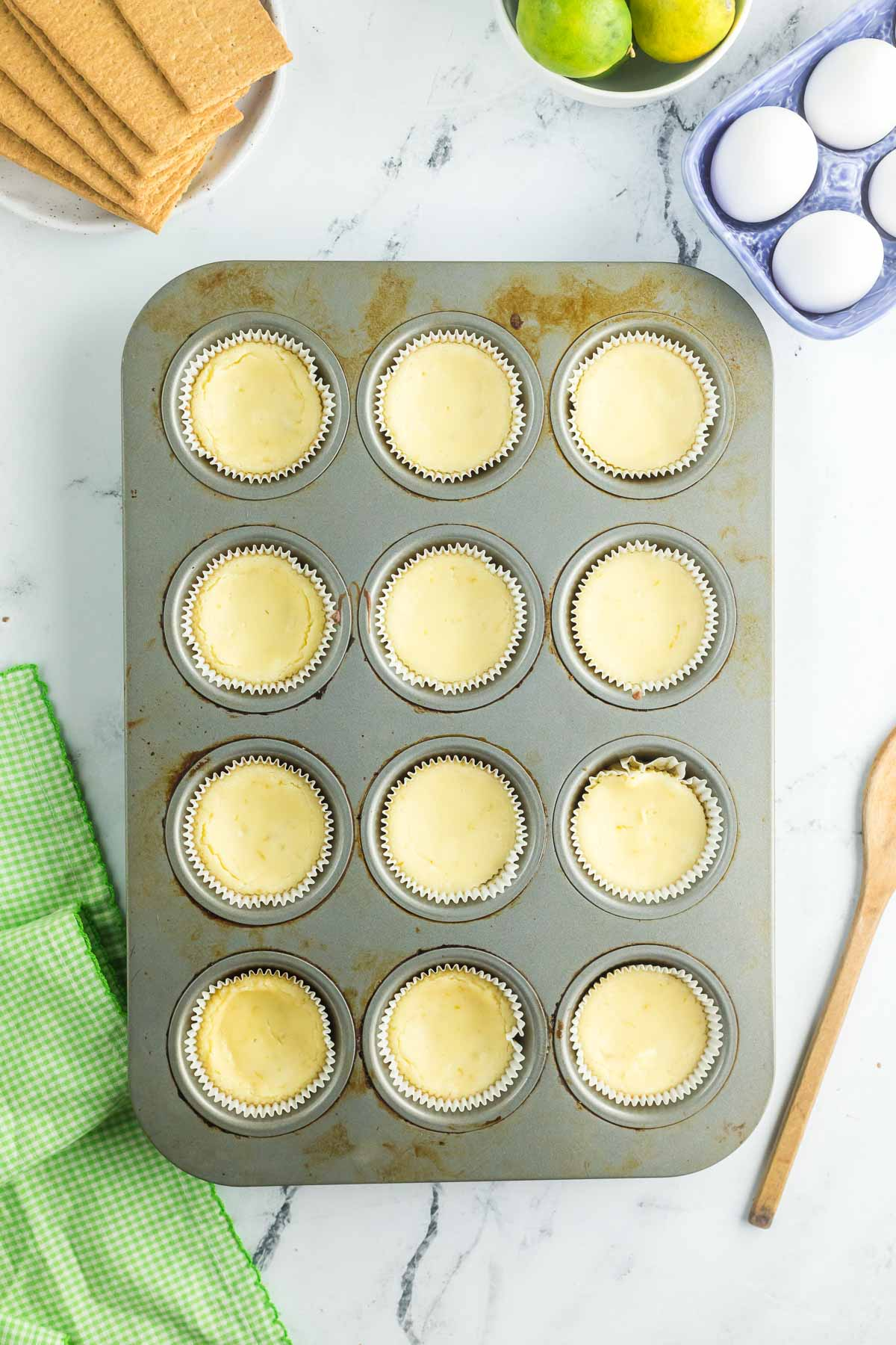baked mini key lime cheesecakes in muffin tin