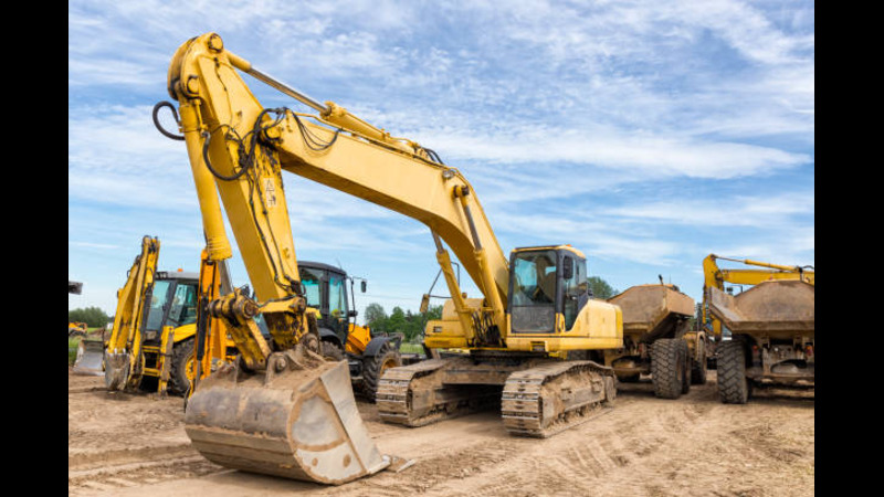 A backhoe digging soil. 