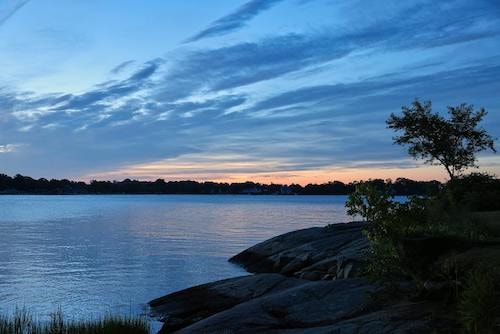Sunrise on a lake under a cloudy sky on spring getaways in New England