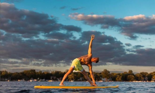 sup yoga on a paddle board