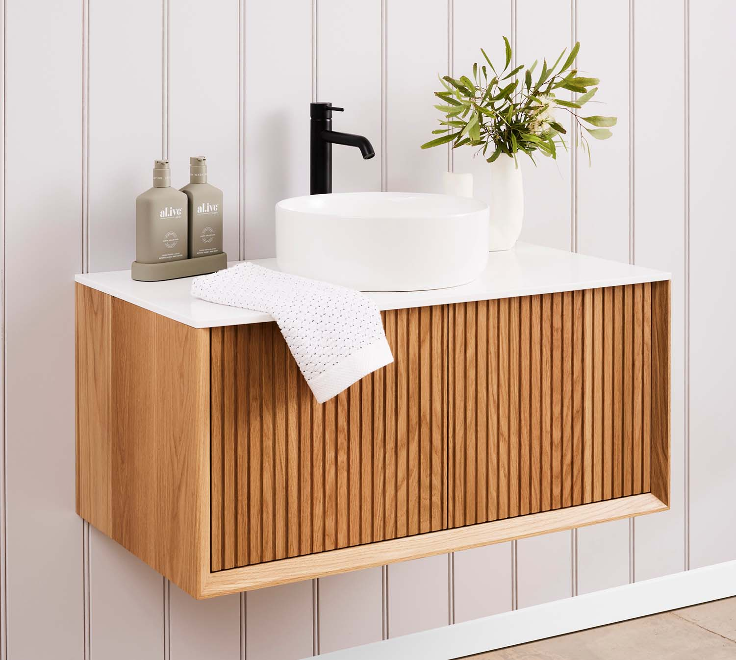 An Archer timber vanity made from American Oak, with a glacier white corian top