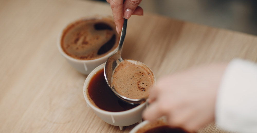 skimming off foam and ground coffee