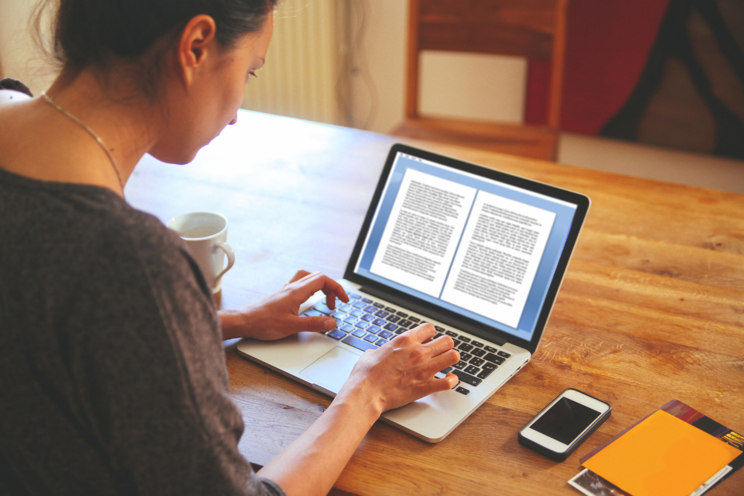 A woman typing on her laptop.