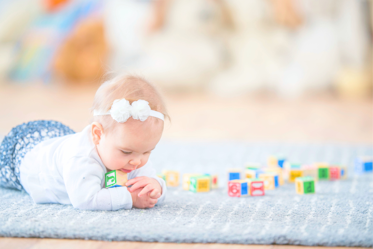 Baby doing Tummy time on a rug