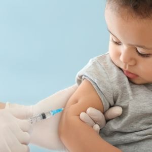 child getting several vaccines