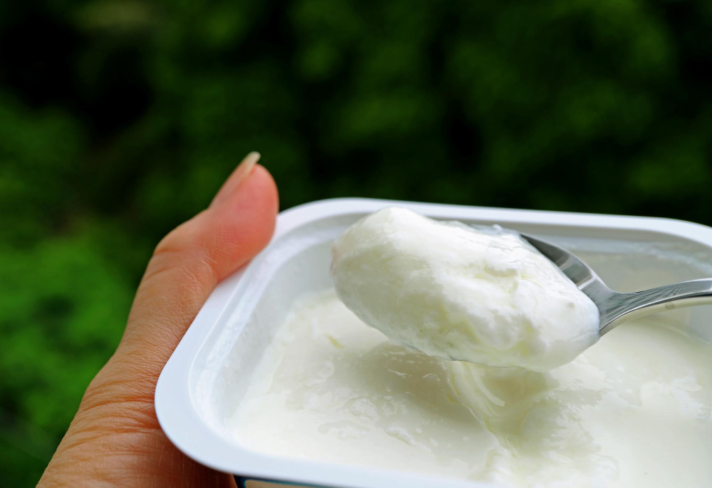 Close-up shot of a spoonful of yogurt, a substitute for coconut milk