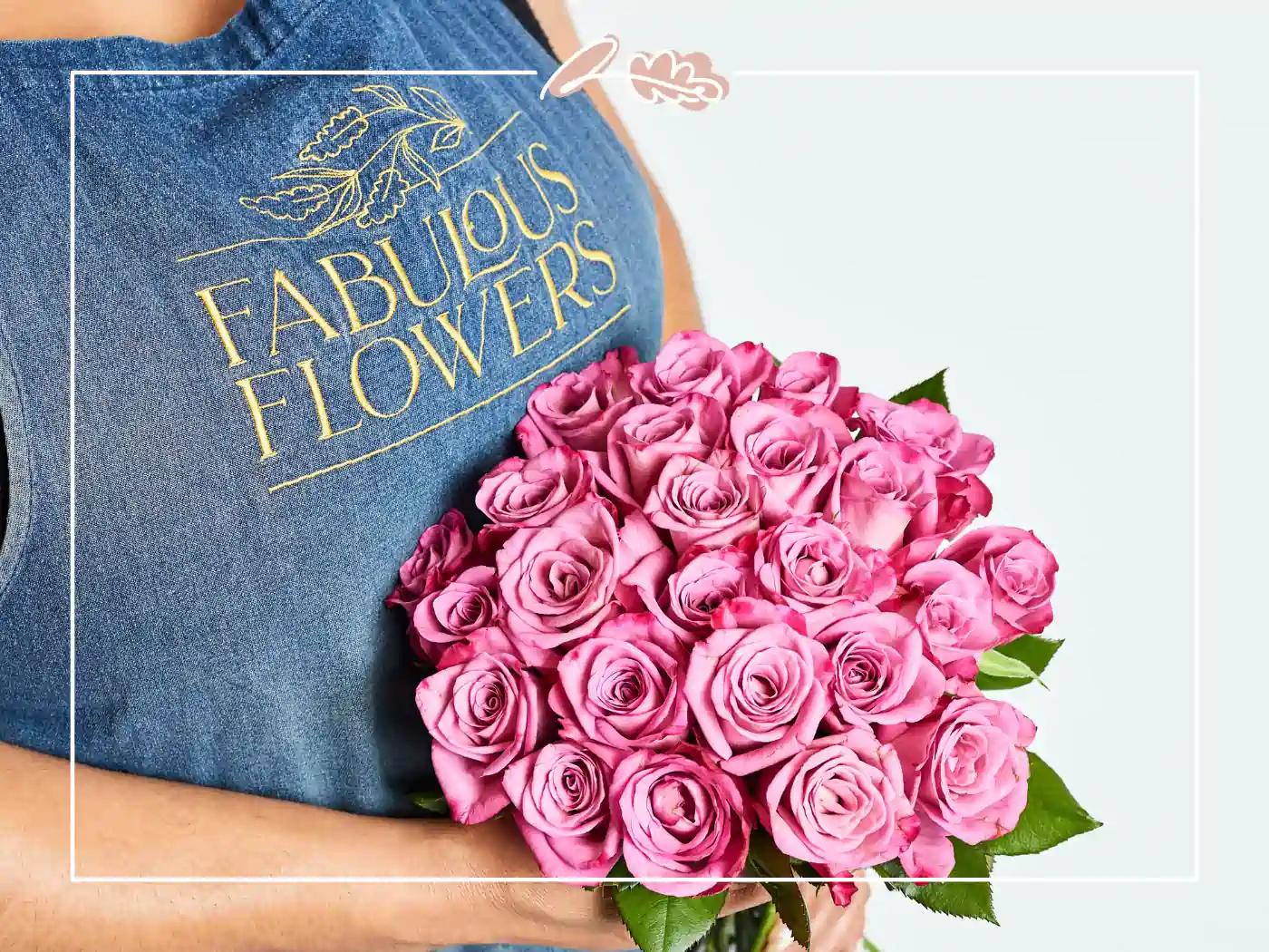 A florist holding a bouquet of fresh pink roses. Fabulous Flowers and Gifts