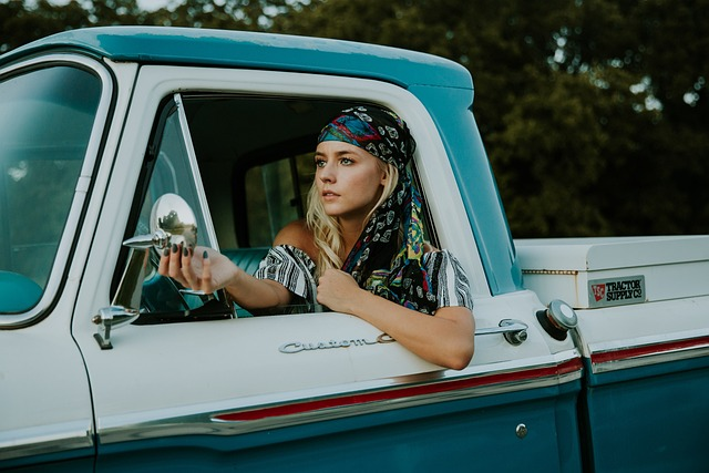 Free-spirited girl driving pickup. 