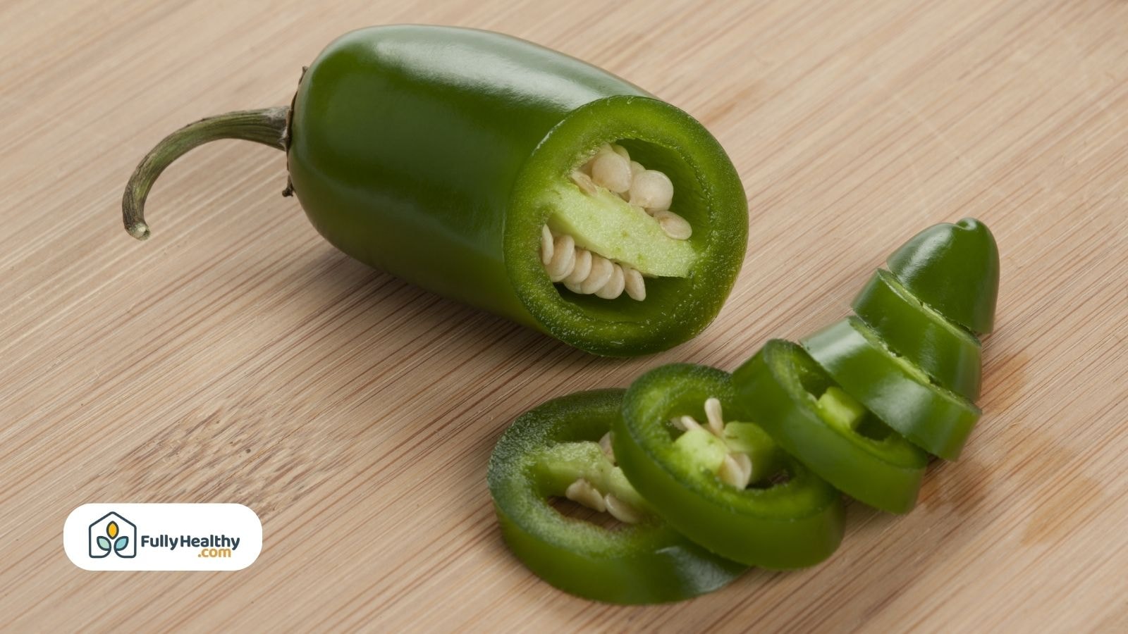 Fresh green jalapeño pepper sliced into rings on board