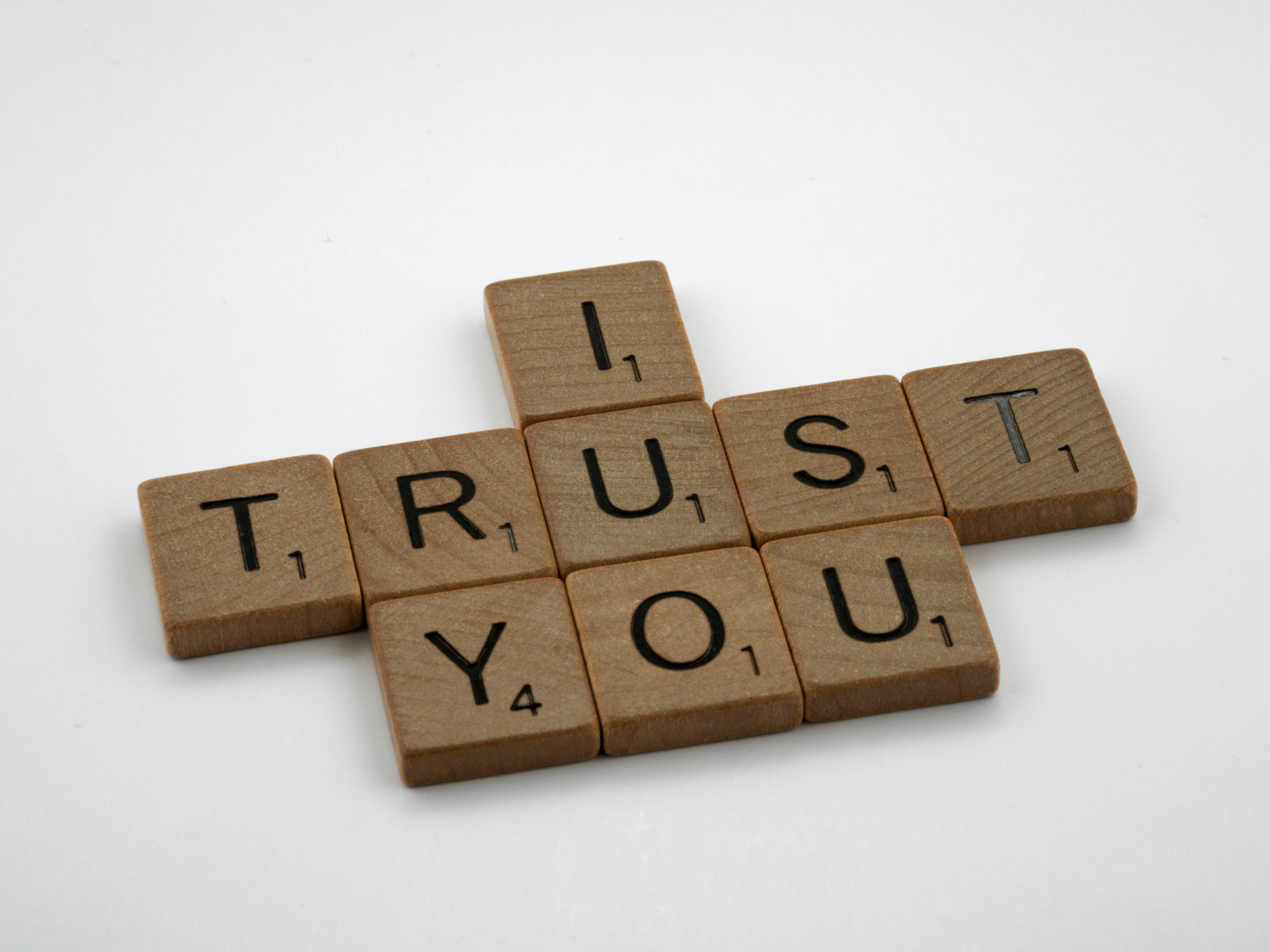 Scrabble letter blocks spelling out "I trust you." We offer GA car transport services like enclosed auto transport.