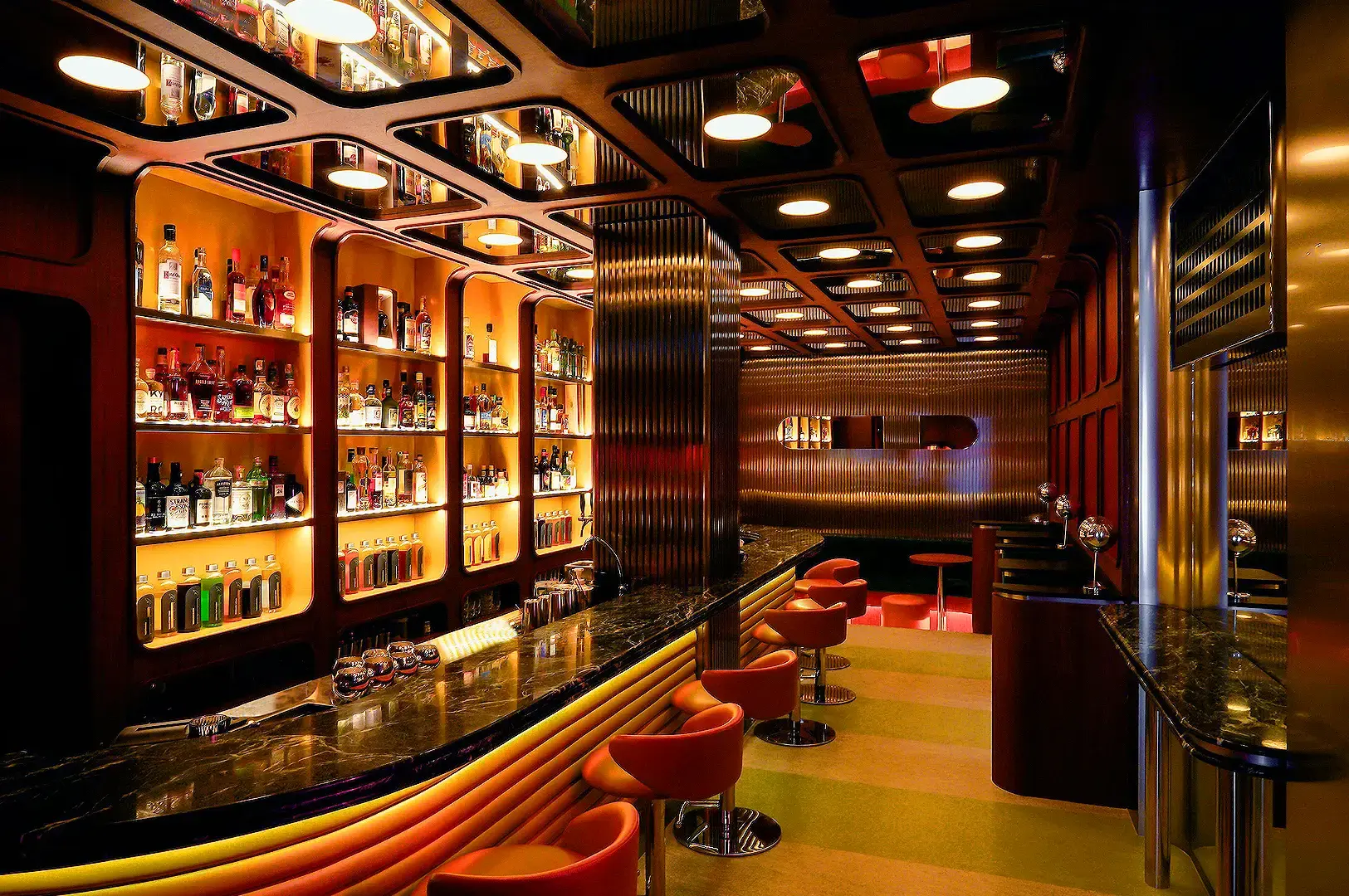 Night Hawk Singapore cocktail bar interior with illuminated liquor shelves