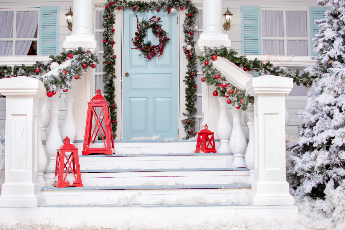 A beautifully decorated front porch with festive Christmas decorations.