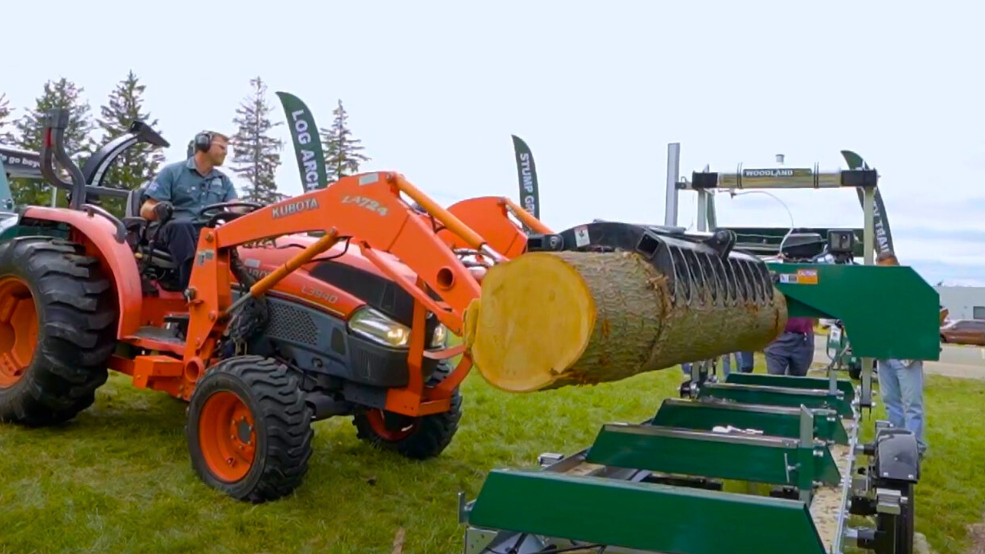 A grapple arm dropping a log on a Woodland Mills sawmill.