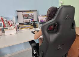 Woman sitting on ergonomic office chair and ergonomic desk chair