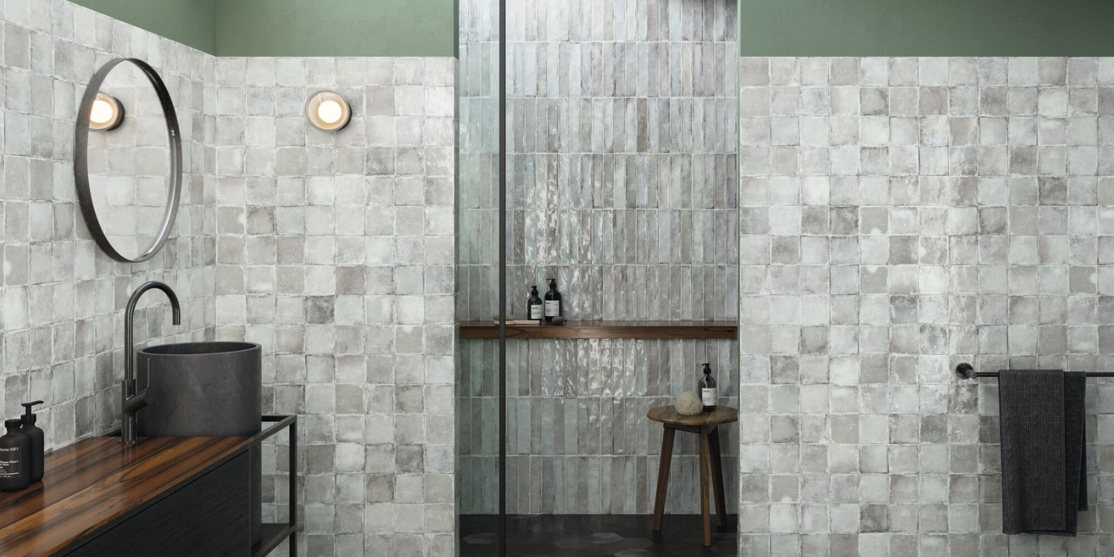 light grey small mosaic wall tiles with sleek black fixtures and accessories.