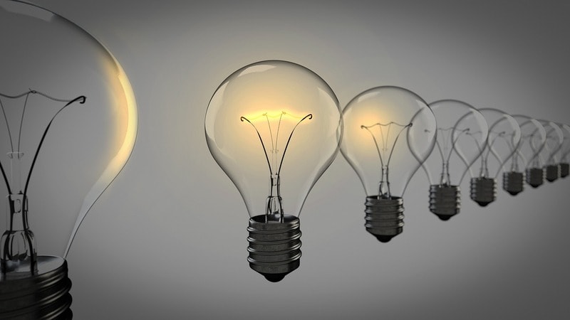 Row of A19 light bulbs with one illuminated