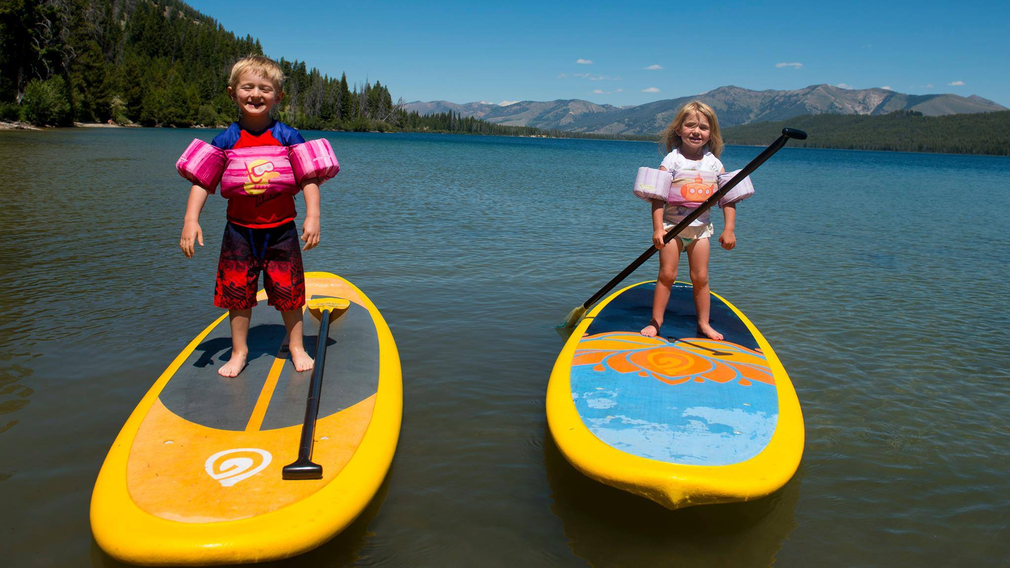 kids on stand up paddle boards