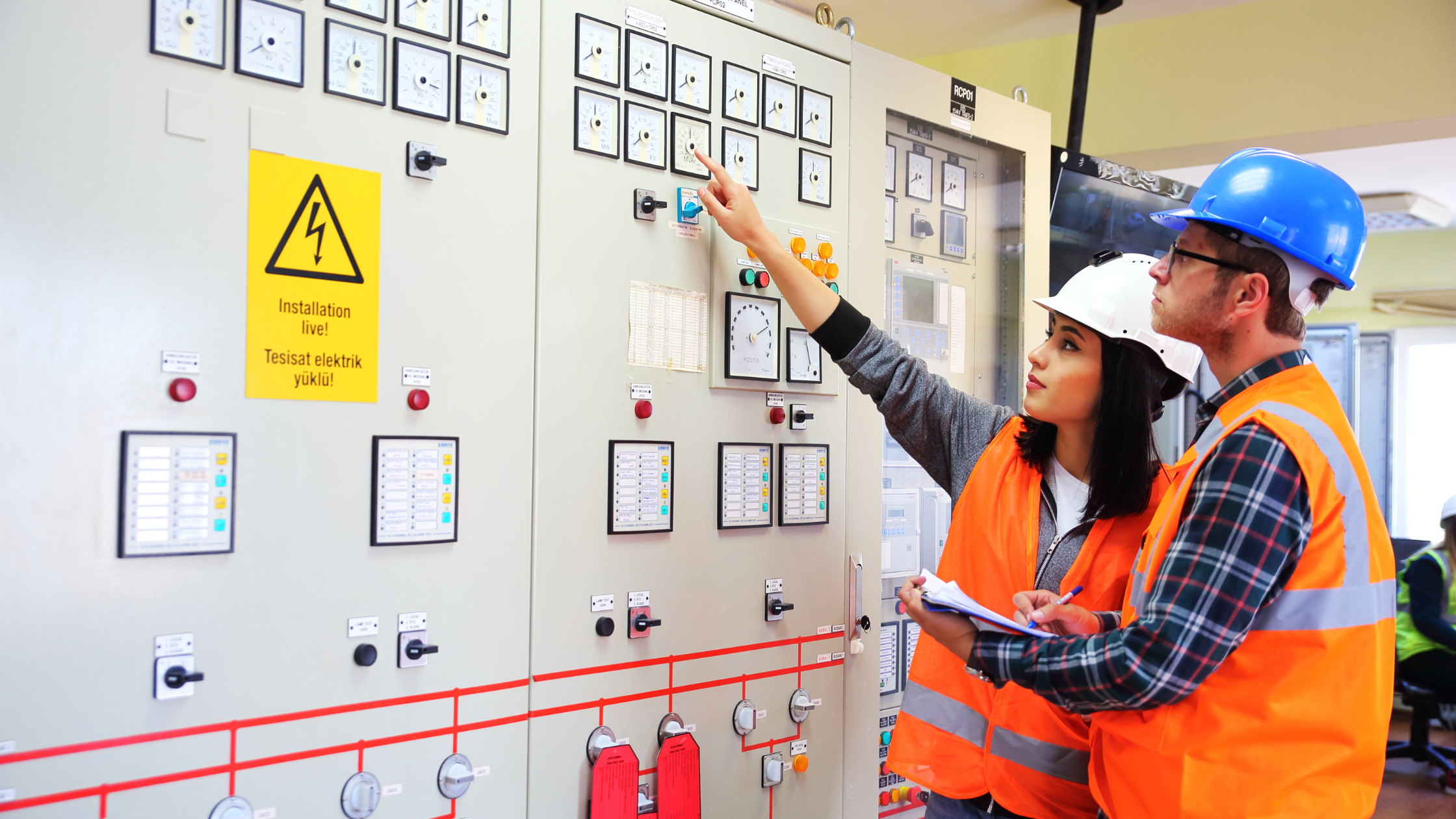 engineers working on an electric panel
