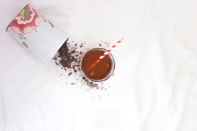Drink on floor with spilled powder next to it