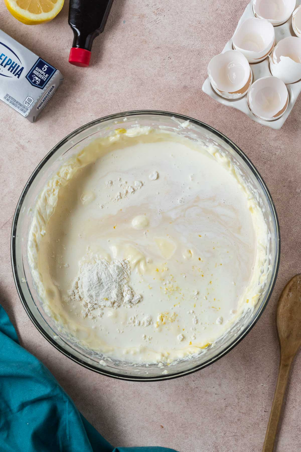heavy cream, flour, vanilla, and lemon zest added to cheesecake mixture in bowl