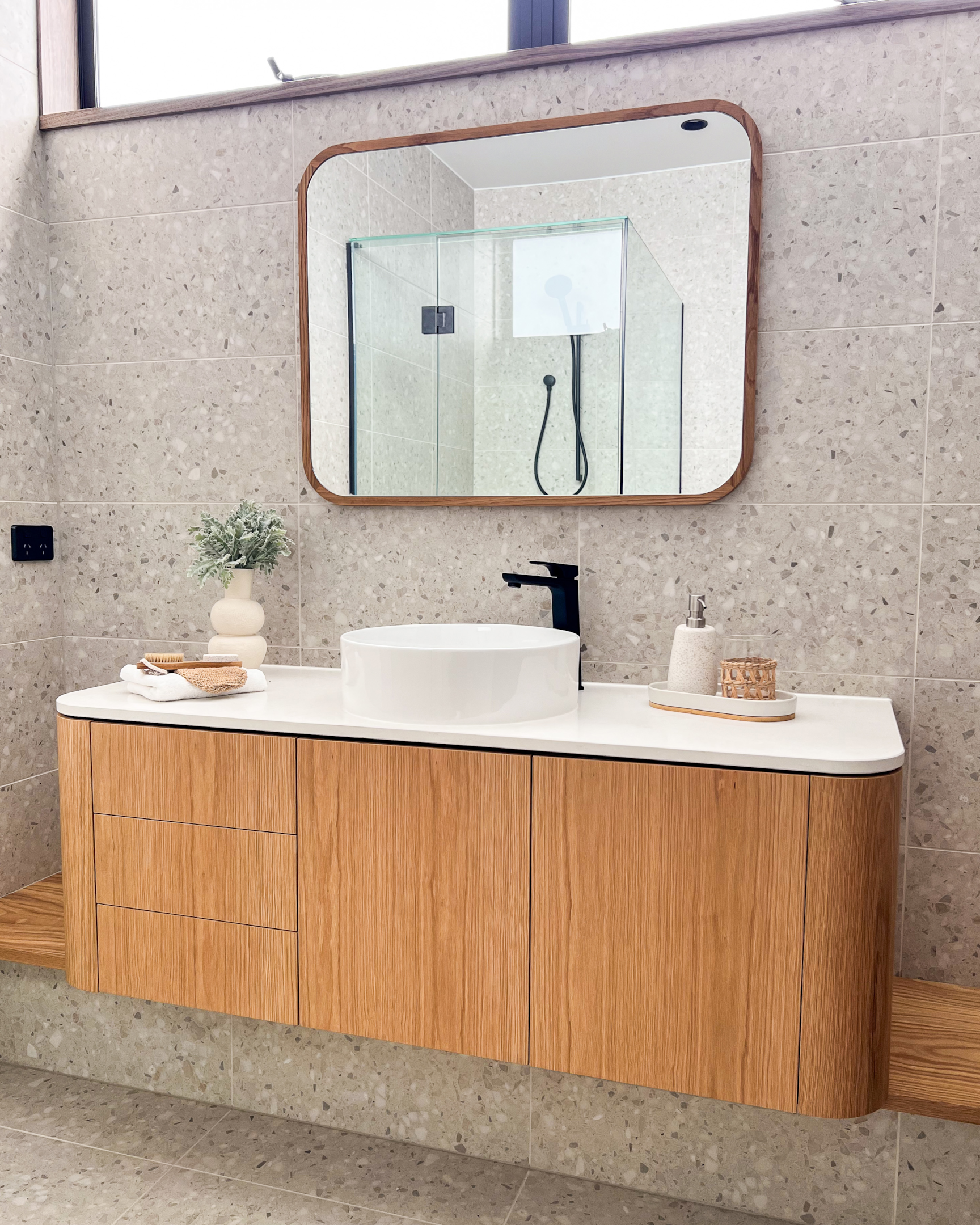 A modern Lomandra wall hung timber vanity in a bathroom