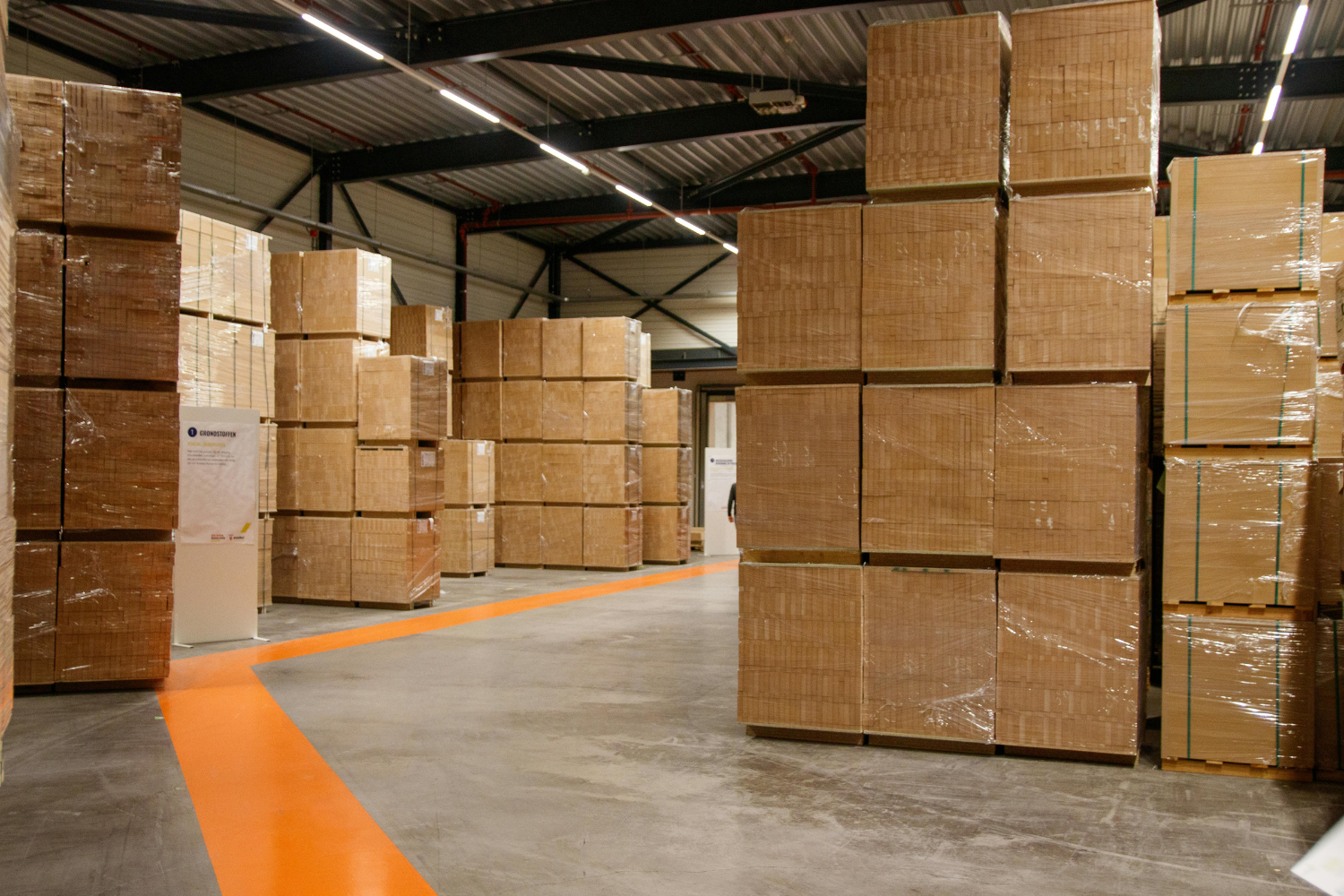 Industrial warehouse used by private label manufacturers with stacked boxes wrapped on pallets for shipping.