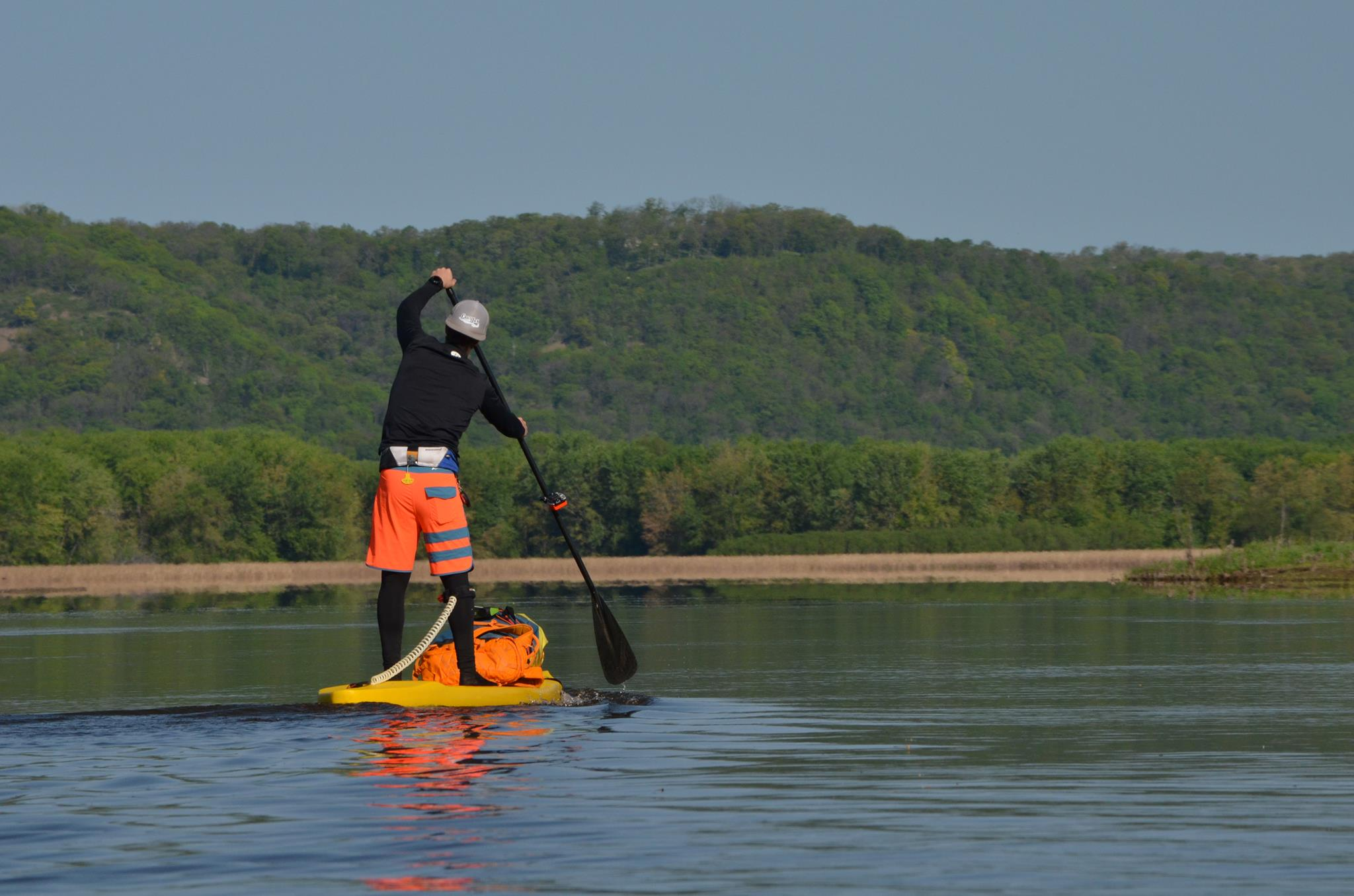 man on stand up paddle board