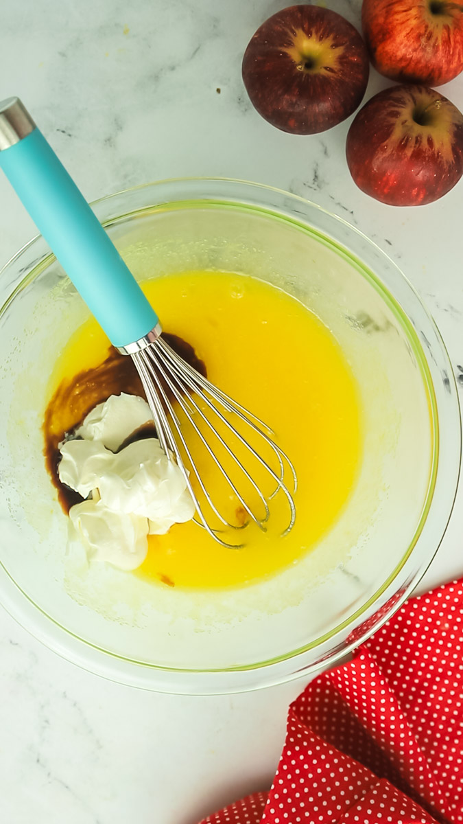 apple bread wet ingredients in bowl with a whisk