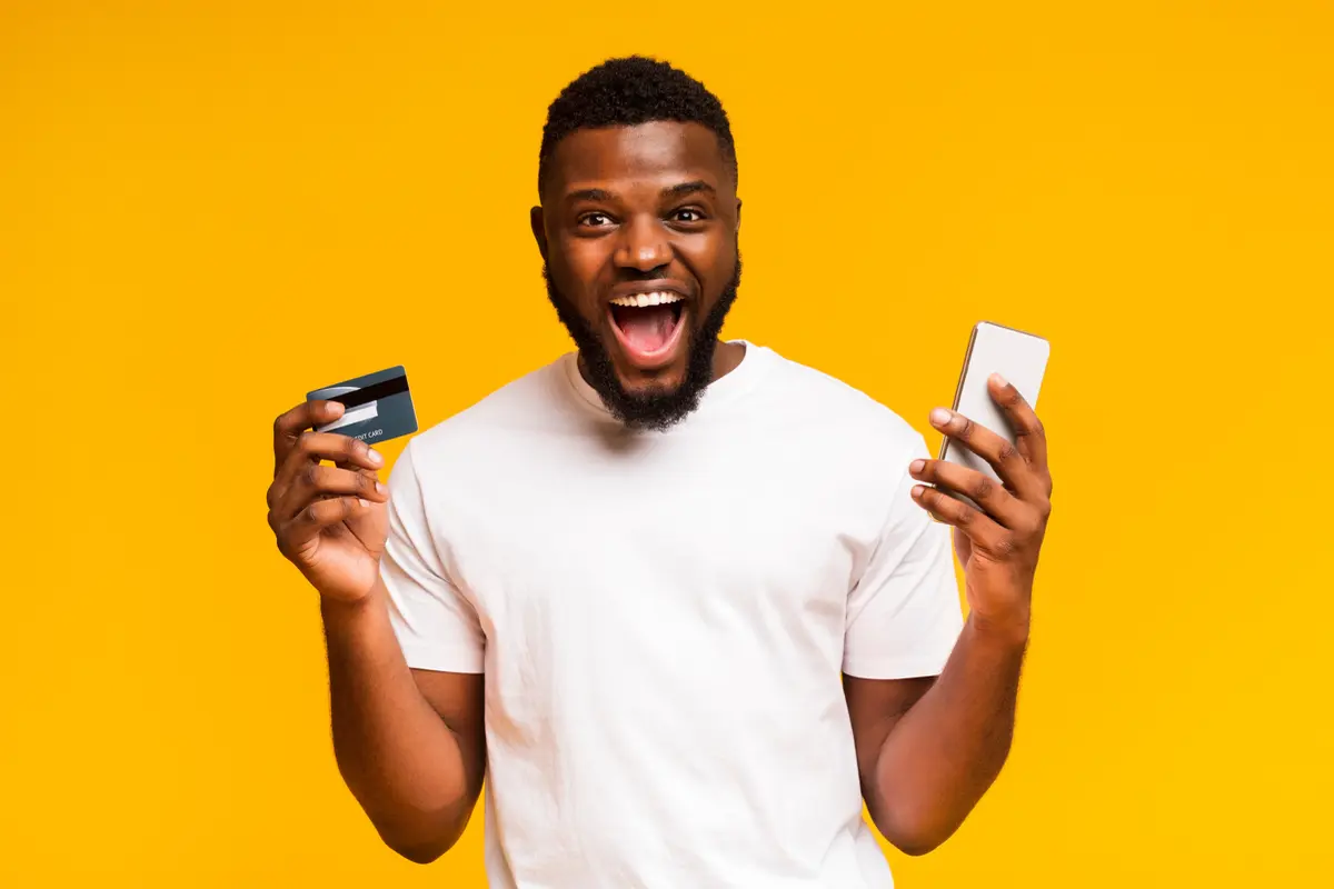 Guy holding card and phone
