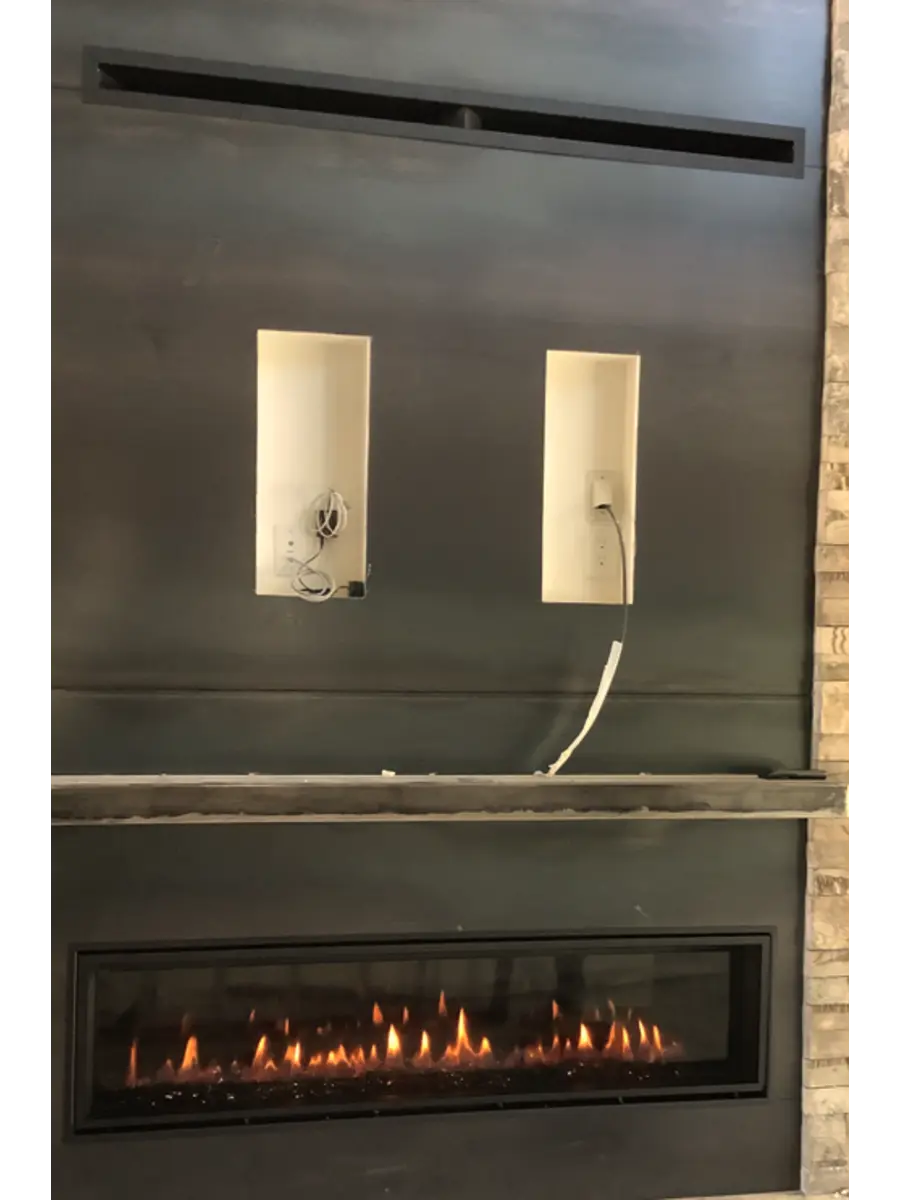 Fireplace will without television installed showing electrical connections.