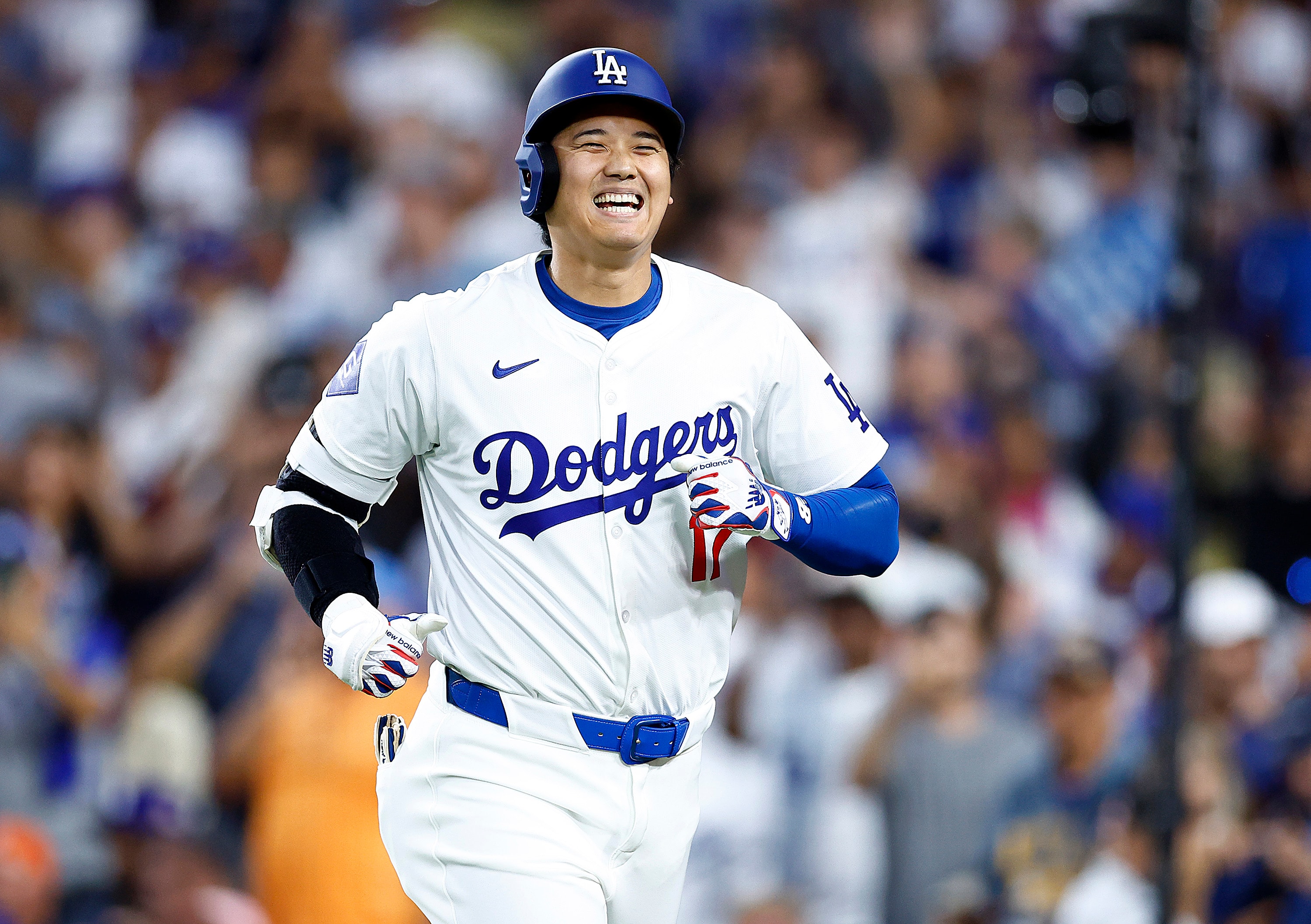 Shohei Ohtani #17 of the Los Angeles Dodgers smiles after hitting a two-run home run against the Pittsburgh Pirates