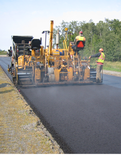 A picture of a modified asphalt binder being poured on a pavement