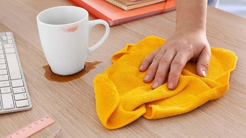 Cleaning up a spill with a Yellow microfiber cloth