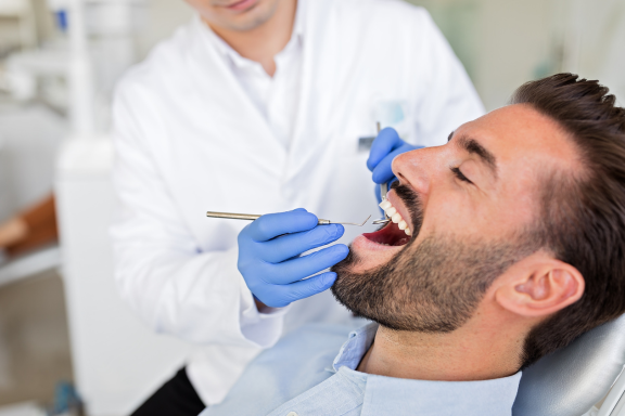 Calgary dentist performs a check up on a patient who had a wisdom tooth removed