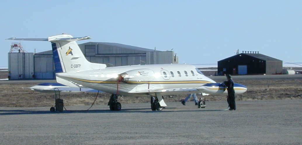 Learjet 25 business jet refueling at an airport in Canada.