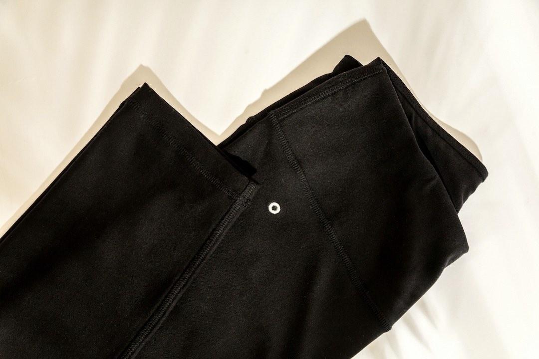 Folded black Orbasics leggings showing the waistband, seams and small embroidered logo.