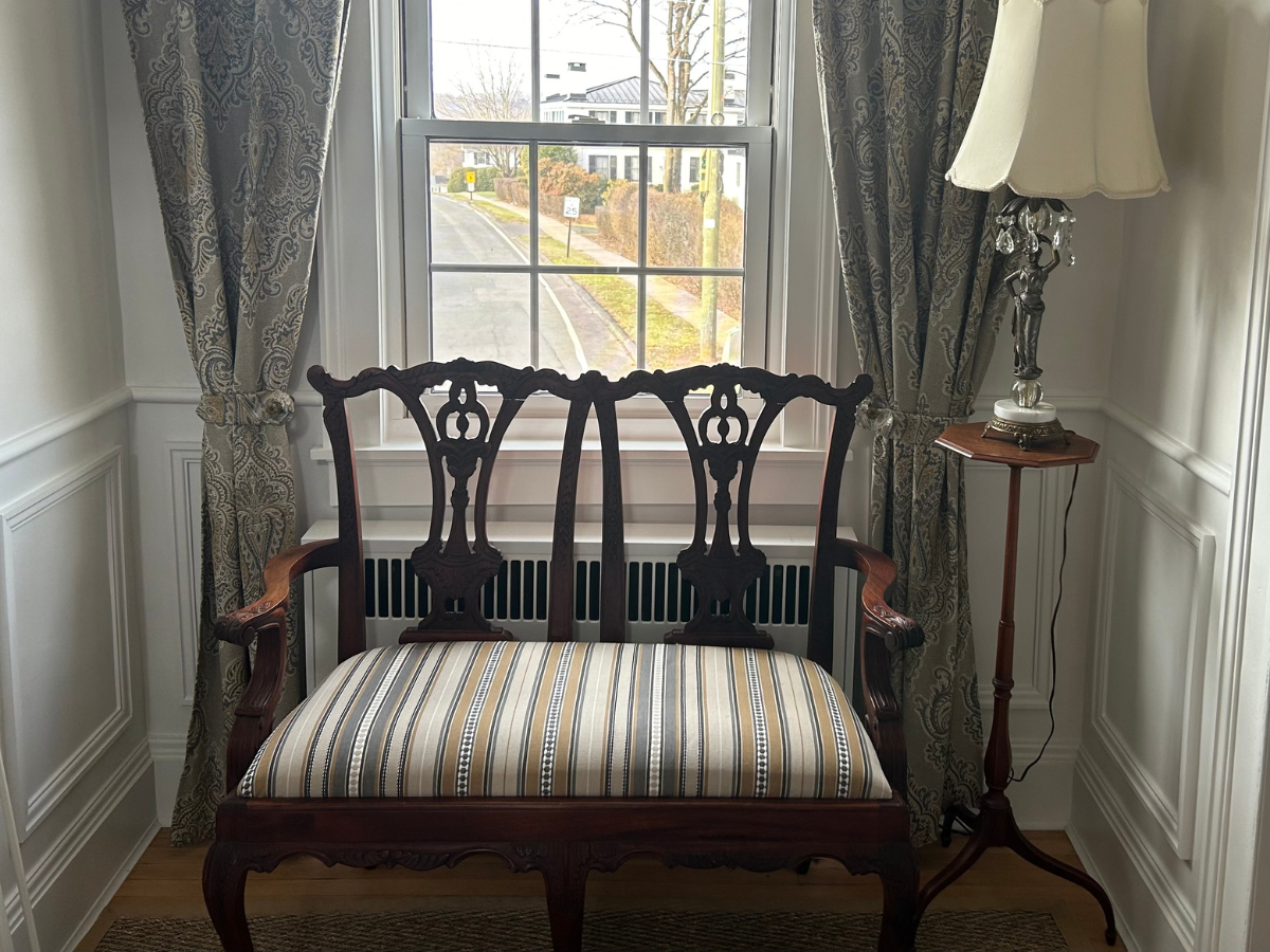 A reupholstered antique Chippendale style bench