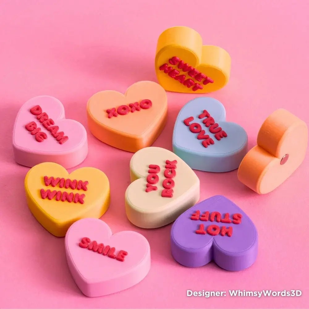 hear shaped 3d printed magnets with text on top