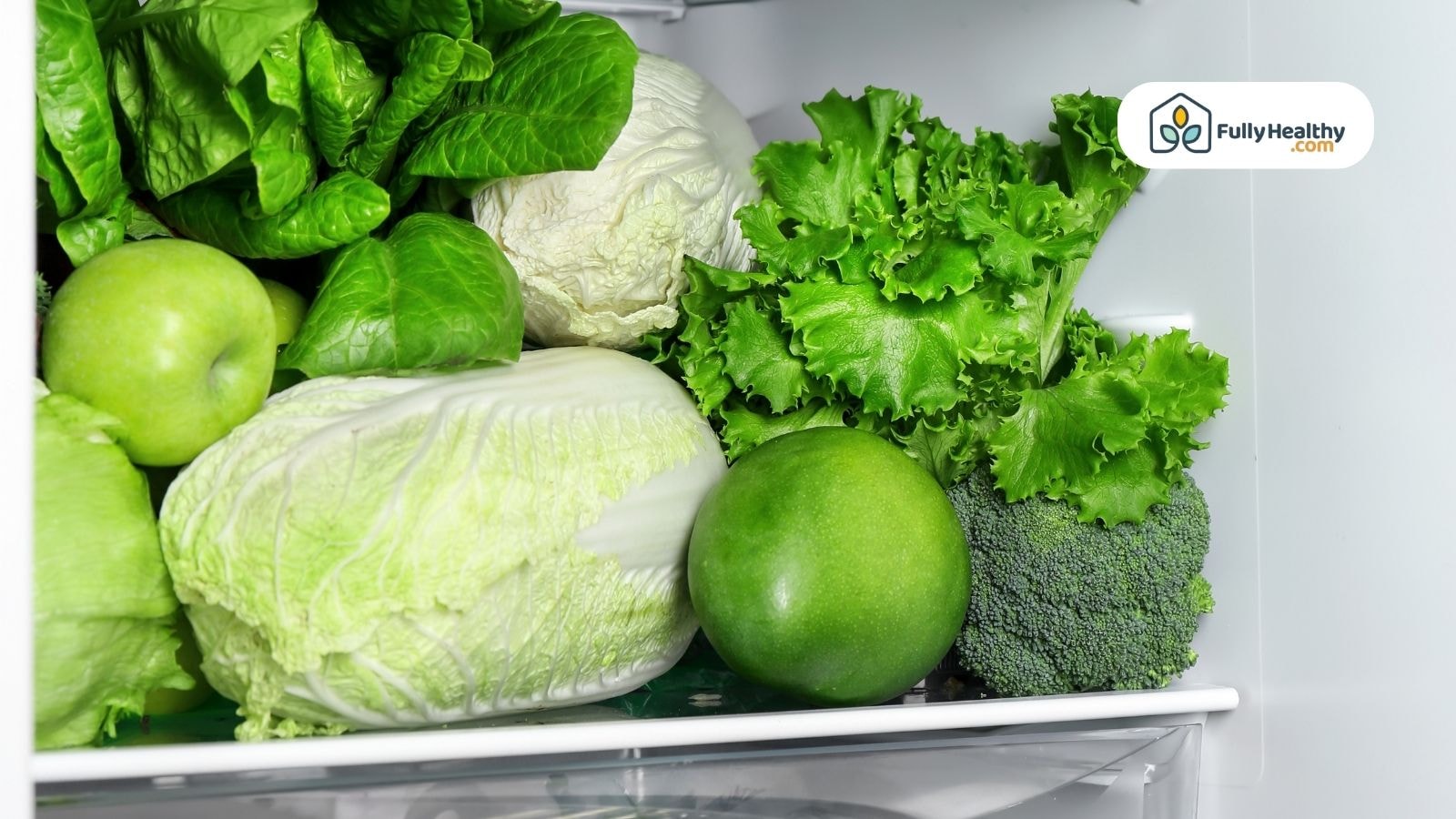 Fresh green vegetables and fruits stored neatly in fridge