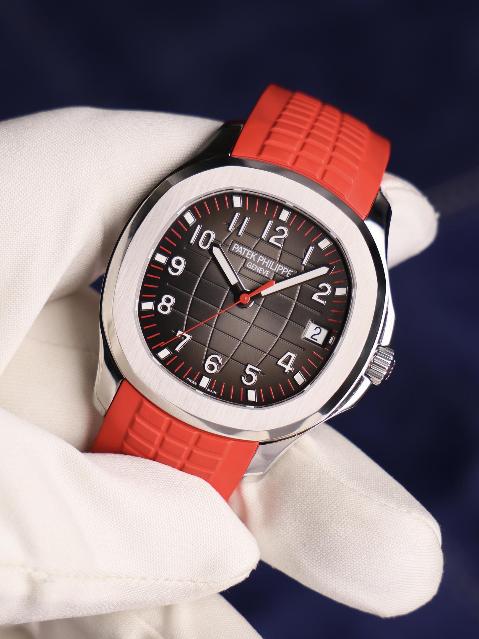 The image features a luxury steel sports watch, showcasing a blue textured dial and a sleek metal bracelet. This exquisite timepiece, reminiscent of the iconic Nautilus by Patek Philippe, exemplifies the brand's commitment to elegant design and precision craftsmanship.