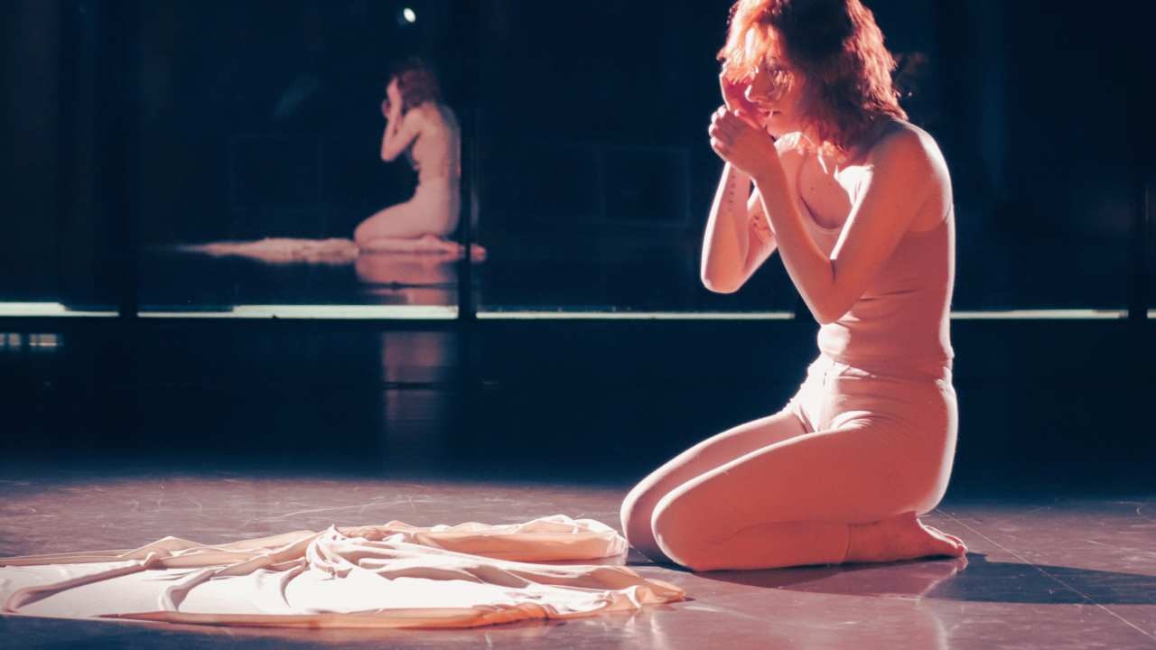 a person doing a dance performance under dramatic light