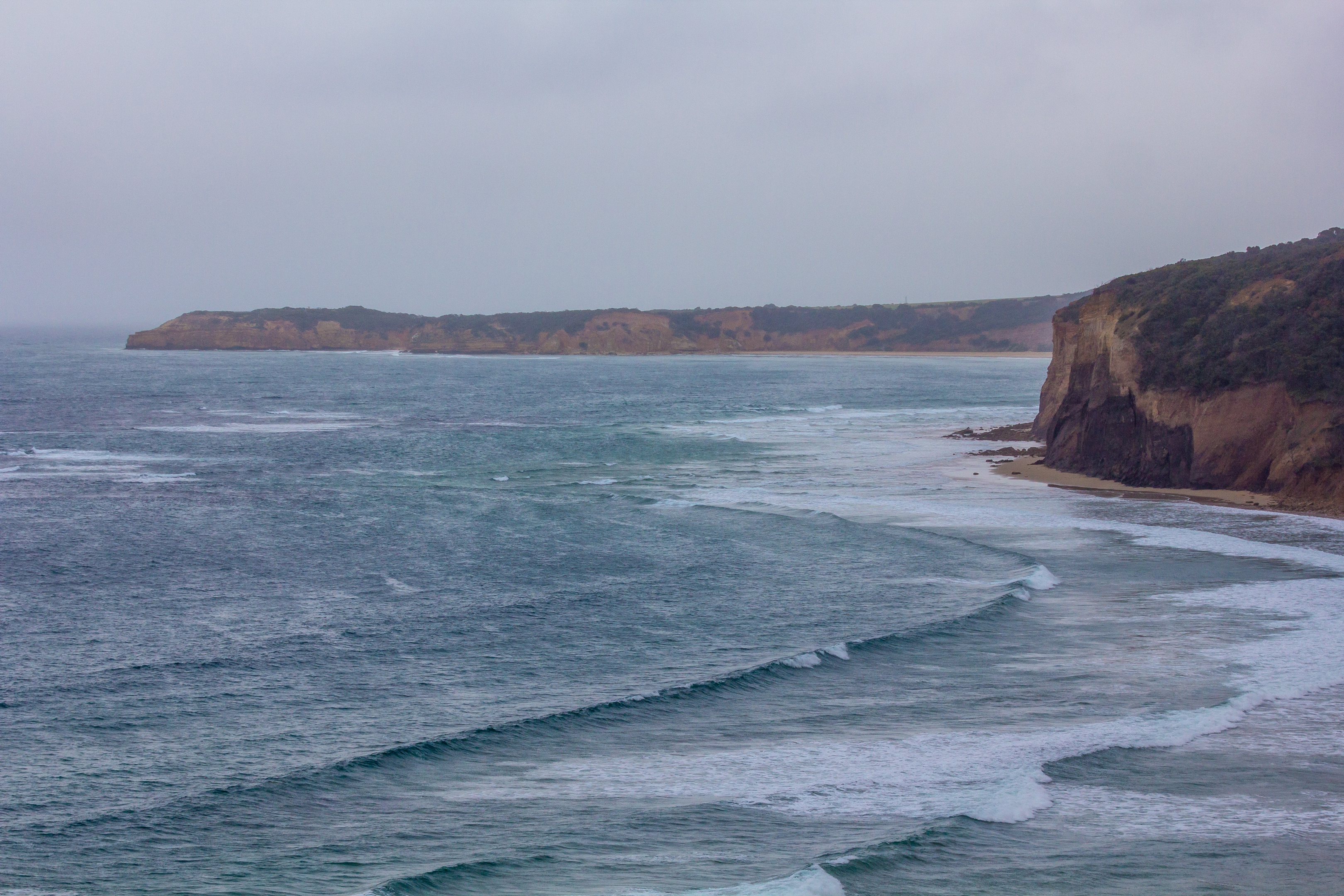  Djpain’s photo of Bells beach. Hamlan Homes Home and Land is etched along the surf coast and coastal road.