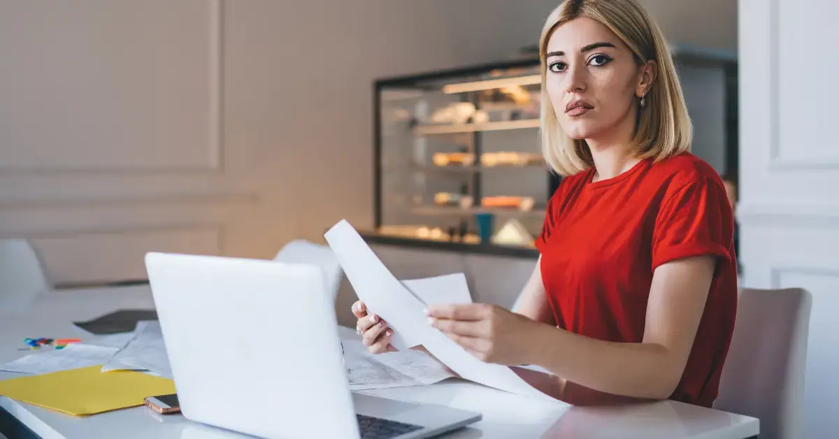 Woman preparing Form 843 with supporting documents for an IRS penalty relief request.